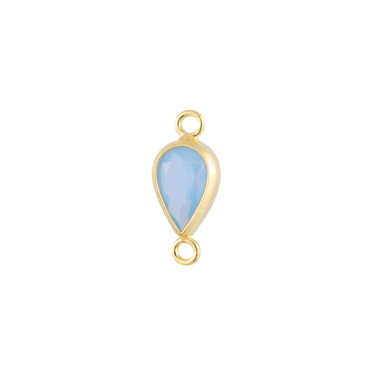 A gold teardrop-shaped jewelry charm with a light blue faceted stone in the center, featuring a top loop and a bottom ring, shown on a plain white background.